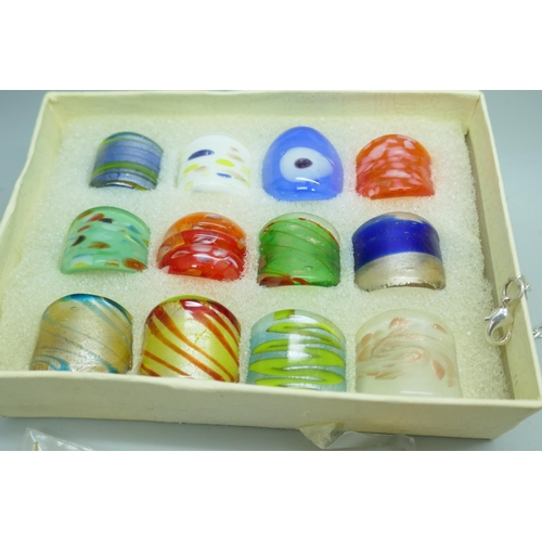 7142 - Costume jewellery including a set of 12 glass rings