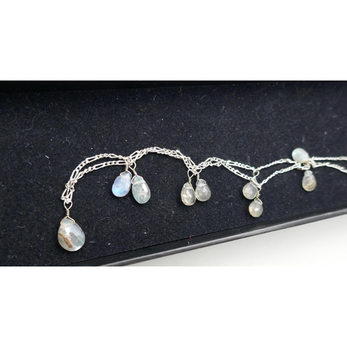 7151 - A silver and moonstone necklace, an uncut opal pendant, a silver and opal ring, and an opalite style... 