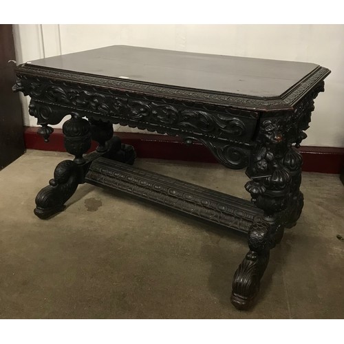 104 - A 19th Century French carved ebonised single drawer centre table