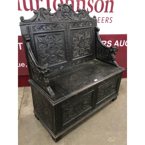 105 - A Victorian Jacobean Revival carved oak settle