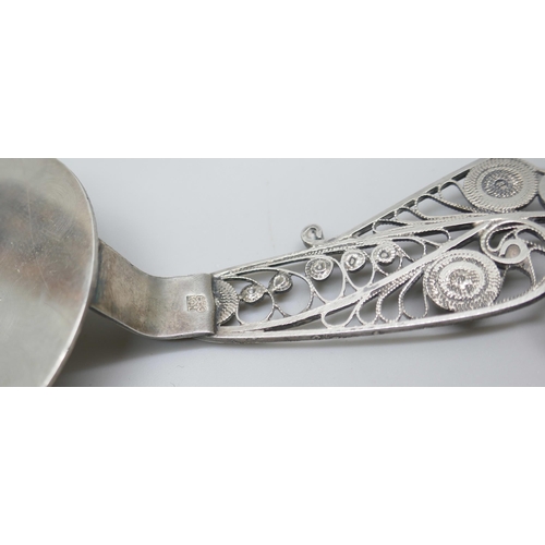 7230 - A .830 silver server, a silver case and a miniature silver two handled bowl, 2cm tall, 49g total