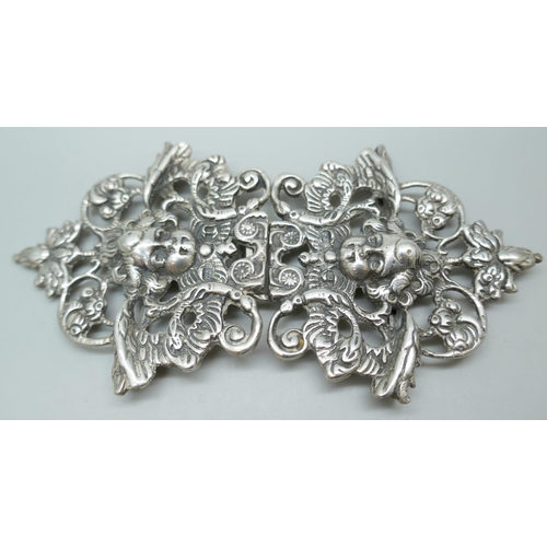 7231 - A silver buckle with cherub design, 11cm, and an Art Nouveau silver buckle, 92g total