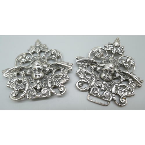 7231 - A silver buckle with cherub design, 11cm, and an Art Nouveau silver buckle, 92g total