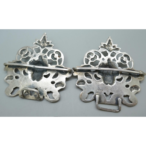 7231 - A silver buckle with cherub design, 11cm, and an Art Nouveau silver buckle, 92g total