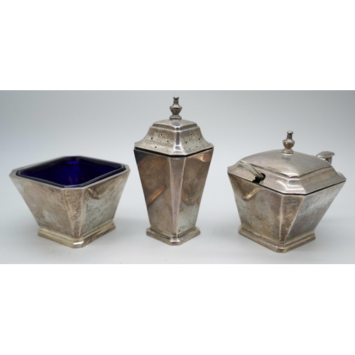 7245 - A Mappin & Webb Art Deco three piece silver cruet set with blue glass liners, Birmingham 1937, unmat... 