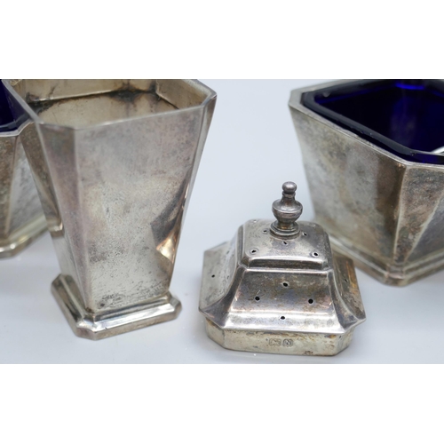 7245 - A Mappin & Webb Art Deco three piece silver cruet set with blue glass liners, Birmingham 1937, unmat... 