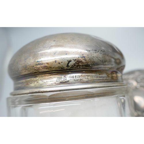 7248 - Three silver topped pots together, 76g silver, with a silver two handled vase, 12cm, and manicure im... 