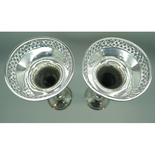 7249 - A pair of pierced silver vases, Walker & Hall, Sheffield 1911, 308g total weight (weighted bases), 1... 