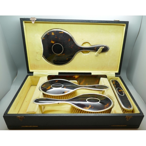 7251 - A silver and tortoiseshell vanity set, Birmingham 1922, lacking one brush