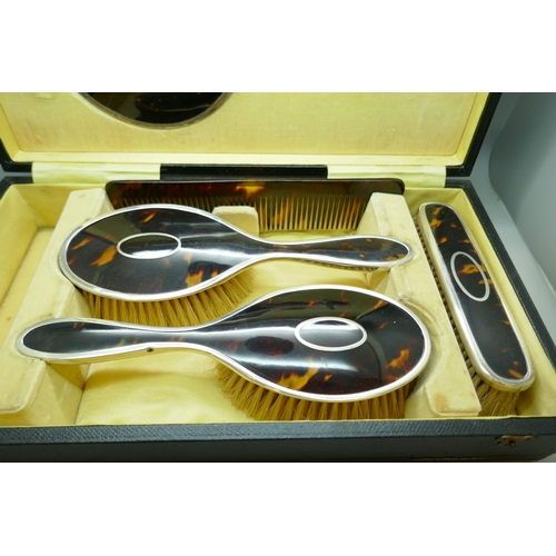 7251 - A silver and tortoiseshell vanity set, Birmingham 1922, lacking one brush