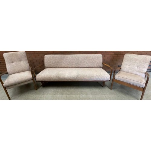 59 - A Greaves & Thomas teak and fabric upholstered three piece lounge suite, comprising; daybed and two ... 