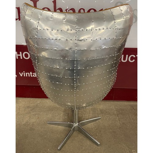 72 - An Aviation style riveted chrome and tan leather revolving egg chair