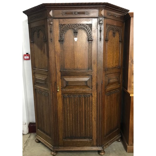 117 - An early 20th Century Jacobean Revival carved oak linenfold hallrobe