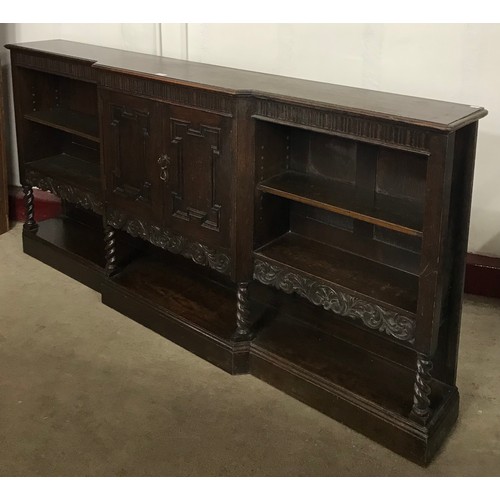 118 - An early 20th Century Jacobean Revival oak barleytwist breakfront bookcase