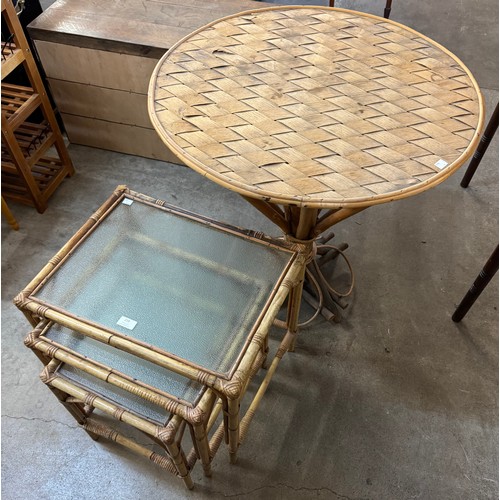 277 - A bamboo circular kitchen table and a bamboo and glass topped nest of tables