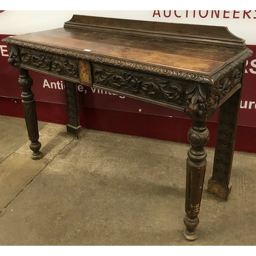 127 - A Victorian Jacobean Revival carved oak two drawer serving table