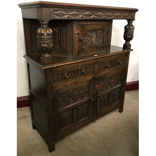 134 - An early 20th Century Jacobean Revival carved oak  court cupboard