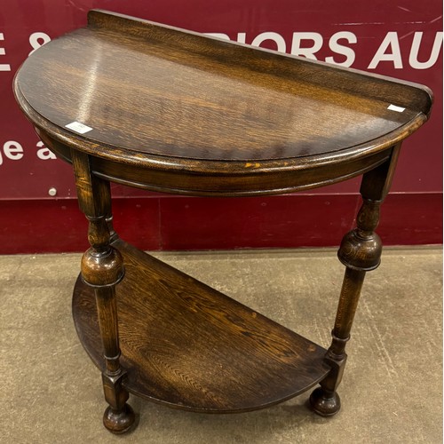 182 - A Queen Anne style oak demi-lune hall table