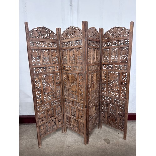 210 - An Eastern carved hardwood folding dressing screen