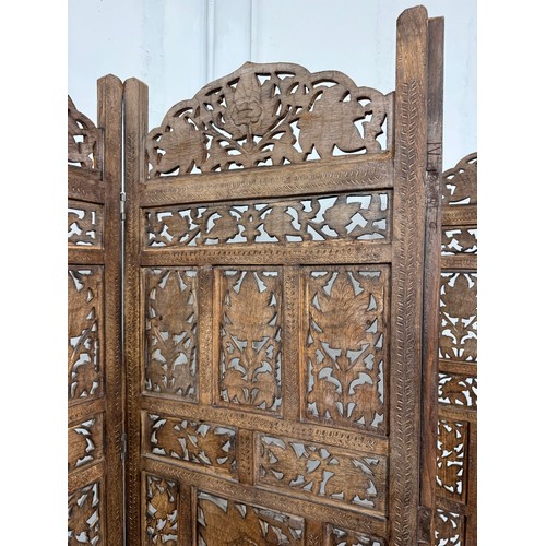 210 - An Eastern carved hardwood folding dressing screen