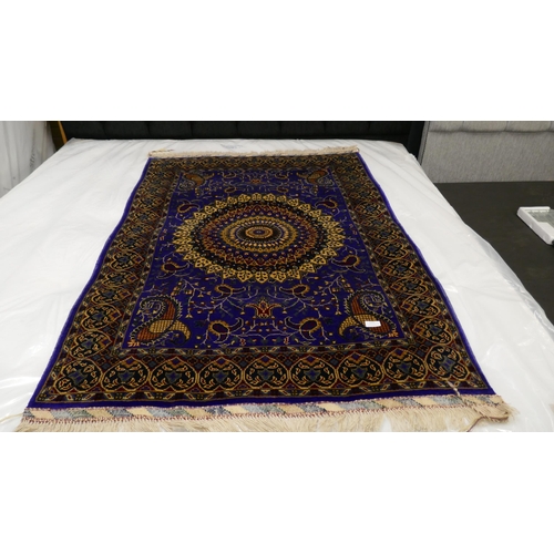 3022 - A blue ground Afghan hand woven double knot rug with central medallion design (woven from Worcester ... 