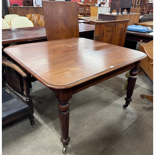 214 - A Victorian mahogany extending dining table