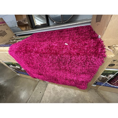 3039 - A full pile pink ground shaggy rug