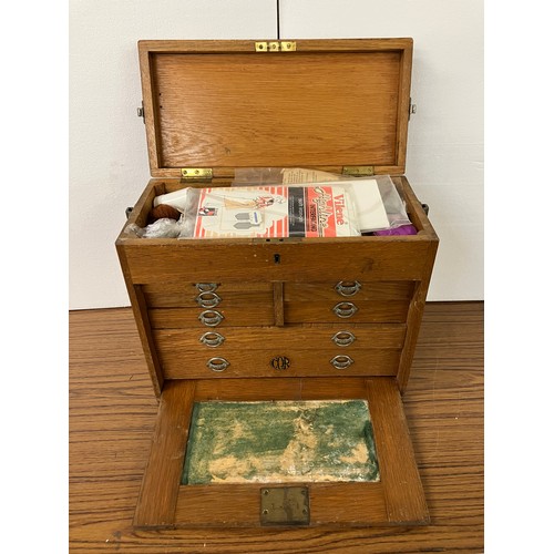 306 - An early 20th Century oak engineers chest, containing thread and other sewing related items