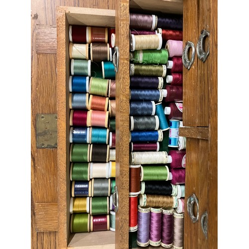 306 - An early 20th Century oak engineers chest, containing thread and other sewing related items