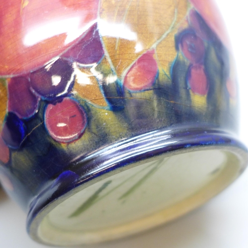 2006 - A Moorcroft pomegranate caddy, impressed mark M122 Y, painted signature, a/f, large crack, 14.5cm