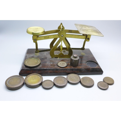 2032 - A set of early 20th Century mahogany and brass postal scales, marked ‘Made in England’ and a collect... 