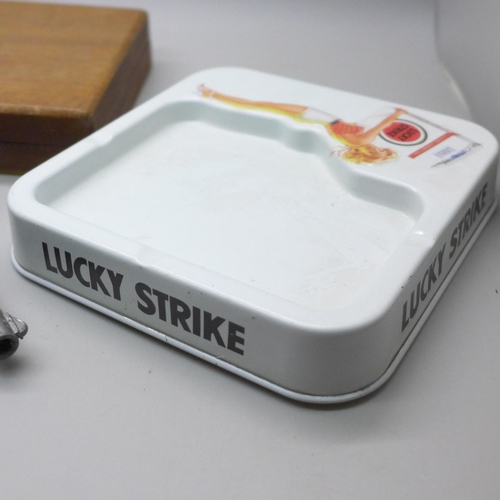 2070 - A Lone Star toy cap gun, a lighter cigarette case combination, a cigarette box, a Lucky Strike ashtr... 