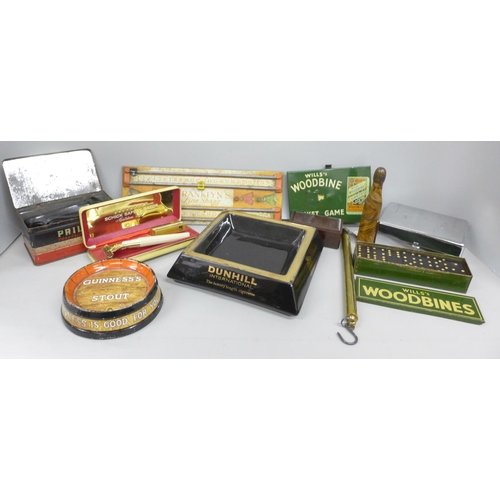 2074 - Two ashtrays, Guiness Stout and Dunhill, a Will's Woodbines tin with dominos and tin-plate cricket g... 