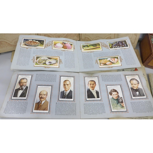 2078 - A collection of cigarette cards, in packets and seventeen albums including 1934 Cricketers, Air Raid... 