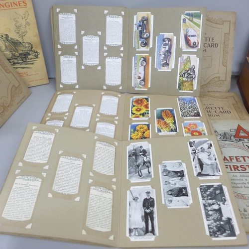 2078 - A collection of cigarette cards, in packets and seventeen albums including 1934 Cricketers, Air Raid... 