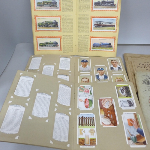 2078 - A collection of cigarette cards, in packets and seventeen albums including 1934 Cricketers, Air Raid... 