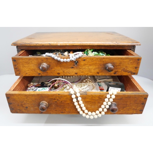 2089 - A collection of costume jewellery with a wooden two drawer chest