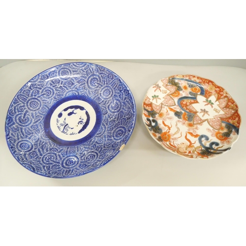 2090 - A collection of oriental pottery, includes a charger and five dishes, charger a/f, large blue dish a... 