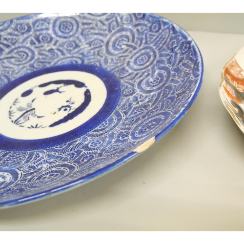 2090 - A collection of oriental pottery, includes a charger and five dishes, charger a/f, large blue dish a... 