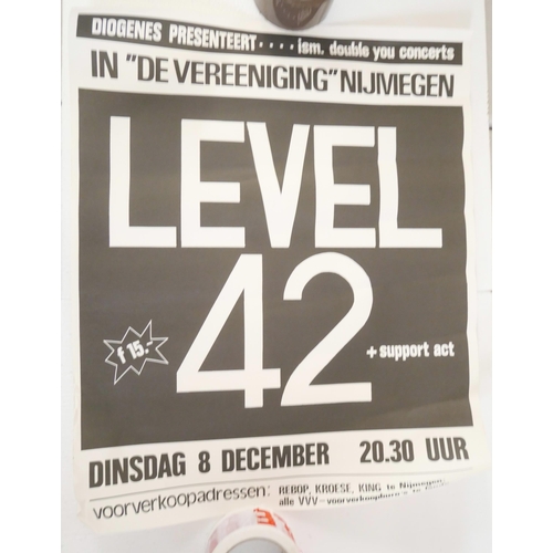 2113 - A collection of four 1980s pop music concert posters including Level 42 and Frank Miller.