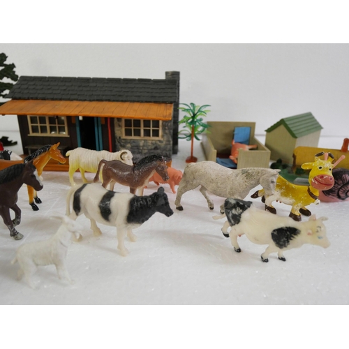 2116 - A box of vintage farm toys comprising buildings, vehicles and various animals.