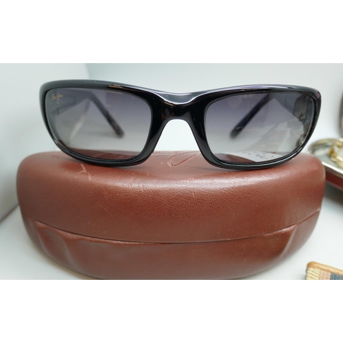 2168 - A pair of Maui Jim sunglasses cased, one other pair of ladies sunglasses and two pairs of spectacles... 