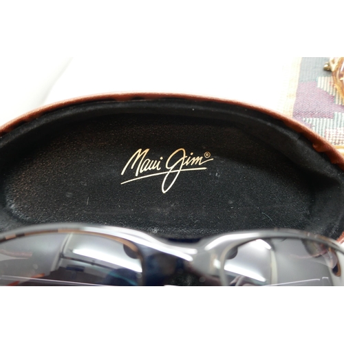 2168 - A pair of Maui Jim sunglasses cased, one other pair of ladies sunglasses and two pairs of spectacles... 