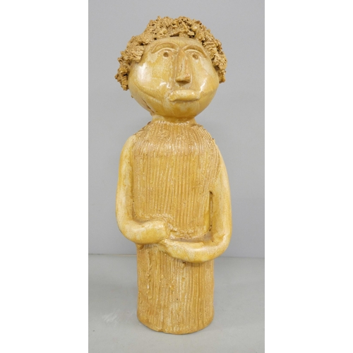 2196 - A mid 20th century oak carving of a young monk reading a book, a carved wooden model of a Germanic G... 