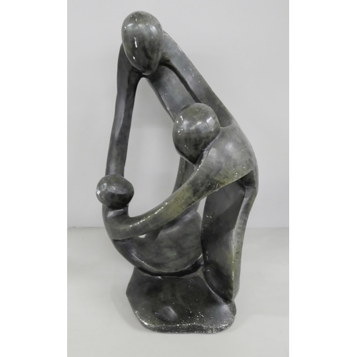 2199 - A soapstone sculptural figure group, three figures embraced in a circle, 32cm