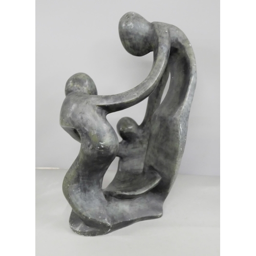 2199 - A soapstone sculptural figure group, three figures embraced in a circle, 32cm