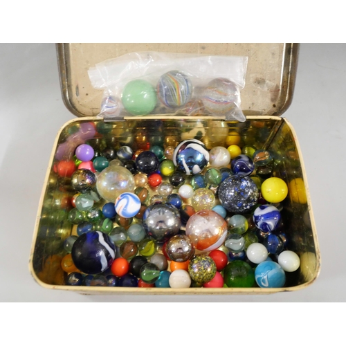 2208 - Two large cylindrical glass jars containing marbles and a tin of marbles, including some latticino