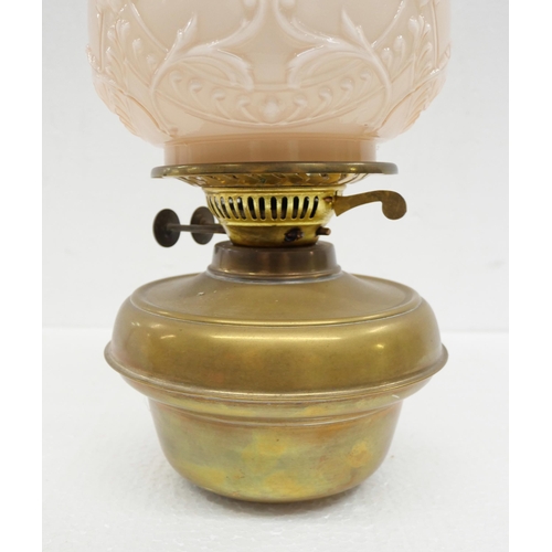 2221 - An oil lamp with pink glass shade **PLEASE NOTE THIS LOT IS NOT ELIGIBLE FOR IN-HOUSE POSTING AND PA... 