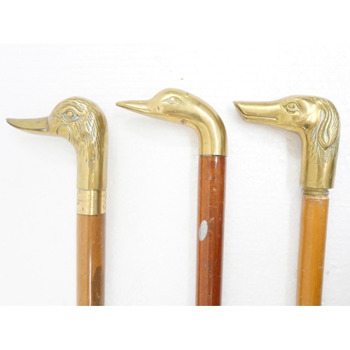 2235 - Three brass duck head walking sticks