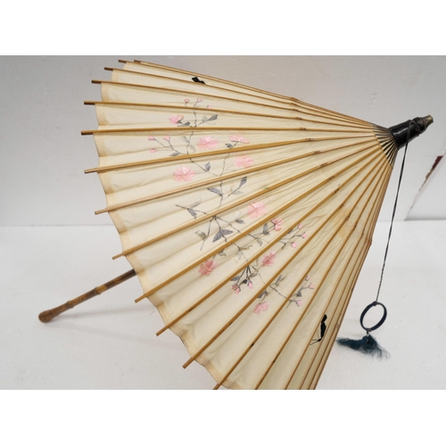 2236 - A walking stick with silver top and a Japanese bamboo parasol